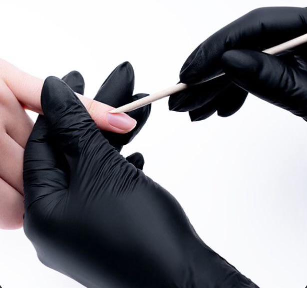 Gloved hands shaping a natural nail